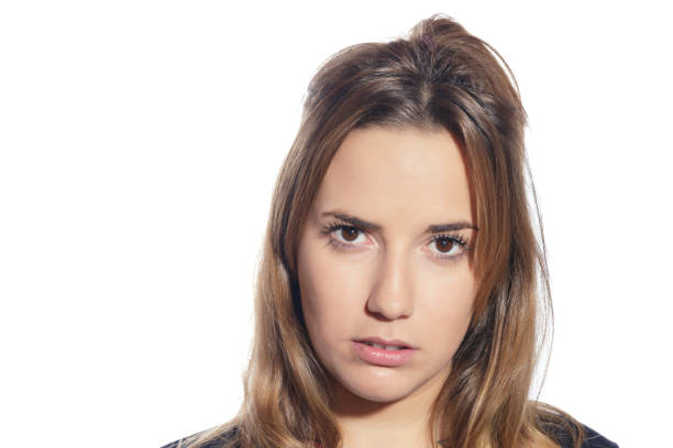 The girl shows discontent on a white background