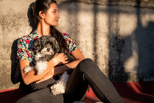 Beautiful woman relaxing on the sun with her dog