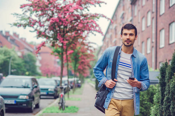 istock casual young man walking to his work 1074043932