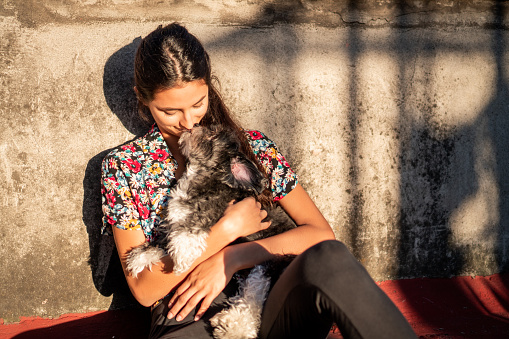 Beautiful woman relaxing on the sun with her dog