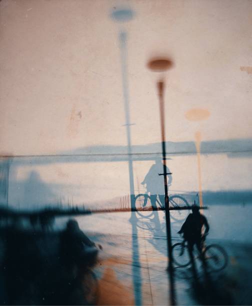 istock Multiple exposure of the cyclist and street light 1074051328