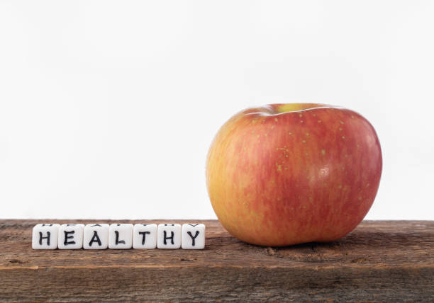 istock Apple on a wood shelf with text lettering spelling out 