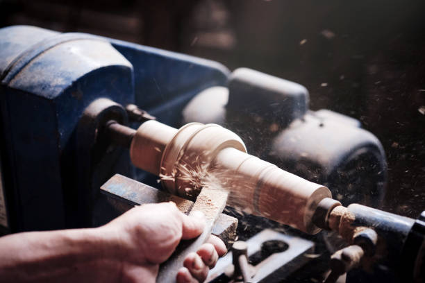 Wood lathe .Closeup hand's the Carpenter lathing wood in Thailand.The Carpenter turning wood on a lathe. Wood lathe .Closeup hand's the Carpenter lathing wood in Thailand.The Carpenter turning wood on a lathe. lathe stock pictures, royalty-free photos & images