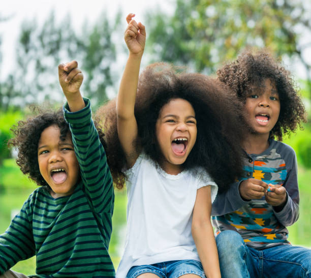 istock Happy kids group playing in the park in school. 1074070306