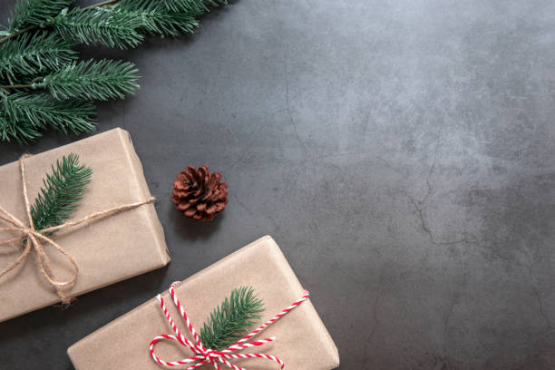 istock Christmas gift boxess pine branches on black background. Flat lay, top view 1074070524