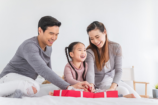 Happy Asian family with Christmas gift box, Asian Christmas and happy new year concept