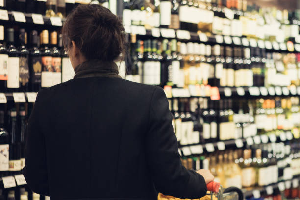 istock Woman shopping wine 1074082288