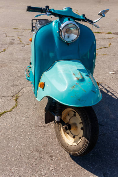 istock Blue retro scooter parked on city street 1074085634