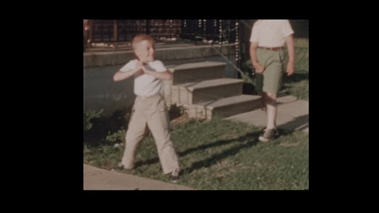 1956 Dad and Son play baseball in front yard