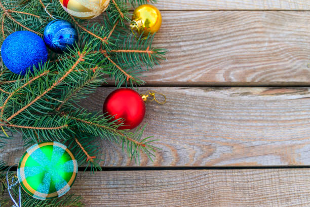istock Christmas composition with fir tree branches and Christmas decorations on wooden table. Top view, copy space 1074092182