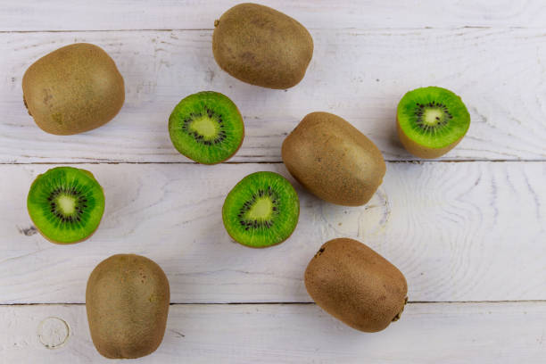 istock Kiwi fruits on white wooden table. Top view 1074098048