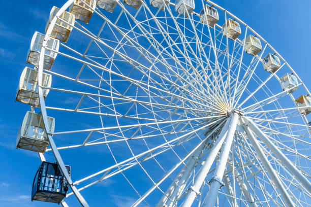 istock Big ferris wheel against the blue sky 1074099178