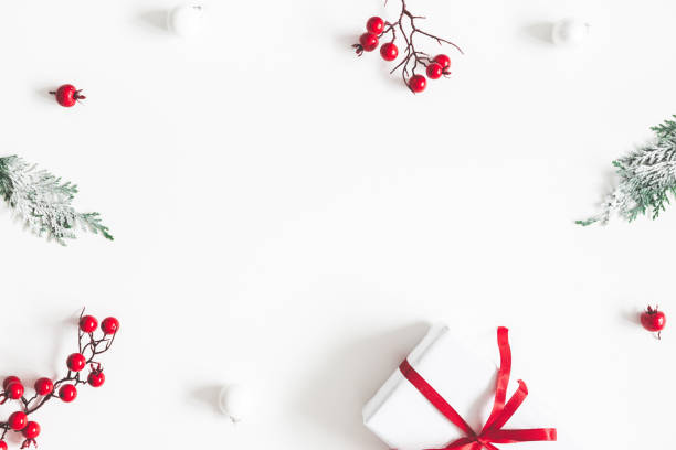istock Christmas composition. Frame made of gift, snowflakes, fir tree branches and red berries on white background. Christmas, winter, new year concept. Flat lay, top view, copy space 1074099808