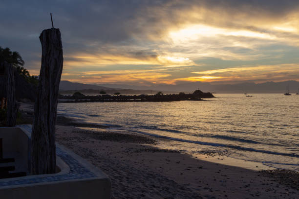 istock sun rays through the clouds from the seawall in Punta de Mita 1074099880