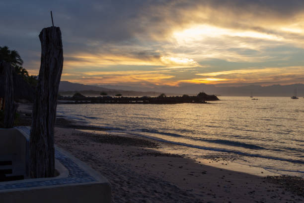 istock sun rays through the clouds from the seawall in Punta de Mita 1074099956