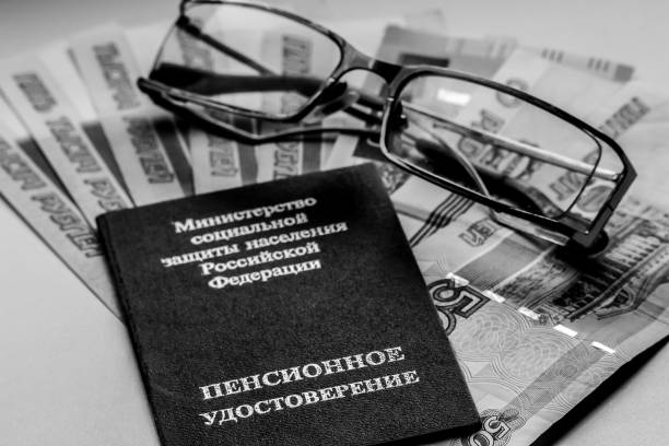 istock Russian pension certificate, glasses and russian rubles (banknotes). 1074101646