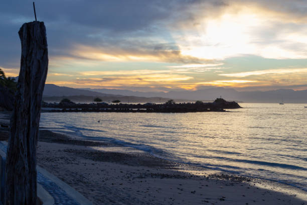 istock sun rays through the clouds from the seawall in Punta de Mita 1074106400