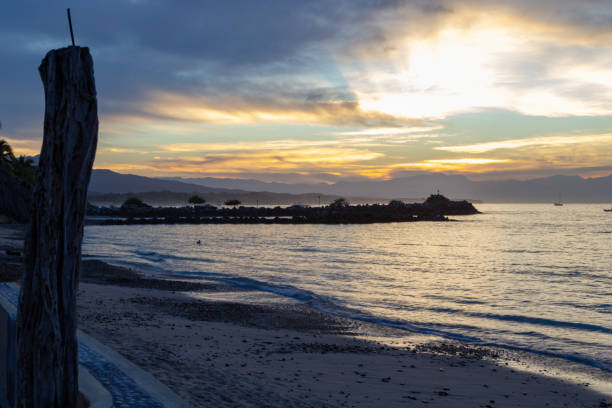 sun rays through the clouds from the seawall in Punta de Mita