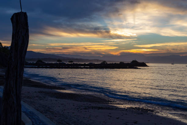 istock sun rays through the clouds from the seawall in Punta de Mita 1074106476