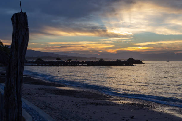 istock sun rays through the clouds from the seawall in Punta de Mita 1074106536