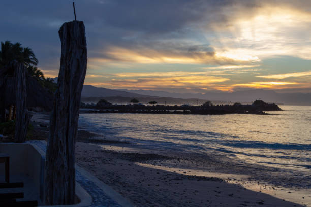 istock sun rays through the clouds from the seawall in Punta de Mita 1074106724