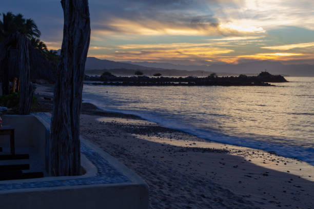 istock sun rays through the clouds from the seawall in Punta de Mita 1074106748