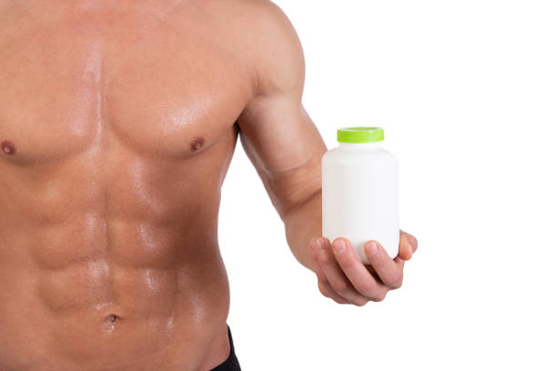 istock Sports supplements and attractive athletic man. 1074111854