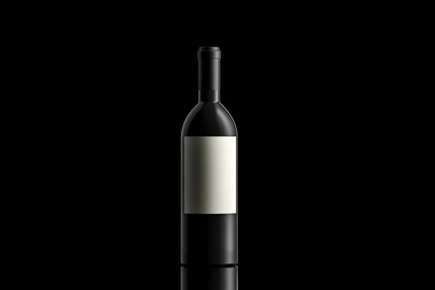 Black wine bottle with an empty label on black background Studio shot of a Black wine bottle on black background with a reflection and copy space. merlot grape photos stock pictures, royalty-free photos & images