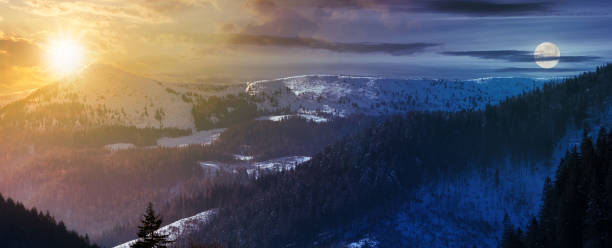 time change with sun and moon above panorama of mountain ridge. lovely winter scenery