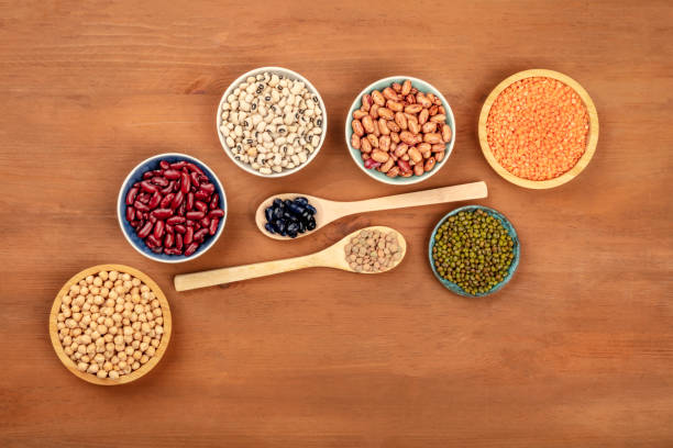 istock Various types of pulses, shot from the top on a dark rustic wooden background with copyspace. Red kidney, pinto, and black beans, lentils, chickpeas, soybeans, black-eyed peas 1074126152