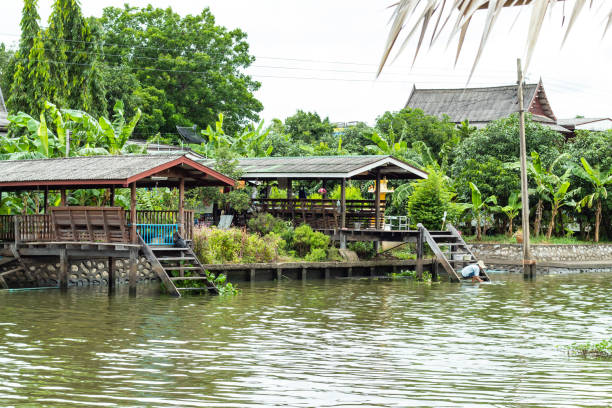 istock Classical wooden Thai House along the canal. 1074126194
