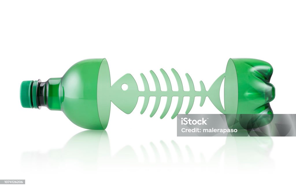 Ocean plastic pollution. Plastic bottle with fishbone on white background. Sea plastic pollution. Plastic bottle with fishbone. Fish Stock Photo