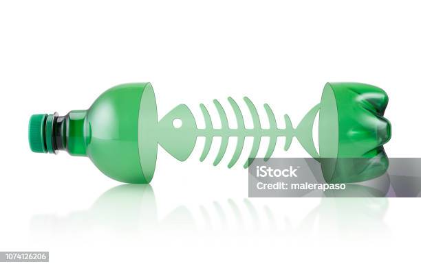 Ocean Plastic Pollution Plastic Bottle With Fishbone On White Background Stock Photo - Download Image Now