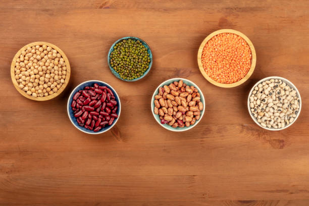 istock Various pulses, shot from above on a dark rustic wooden background with a place for text. Red kidney and pinto beans, lentils, chickpeas, soybeans, black-eyed peas 1074126462