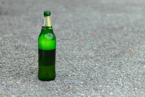 istock Green beer bottles lay on the floor. 1074126488