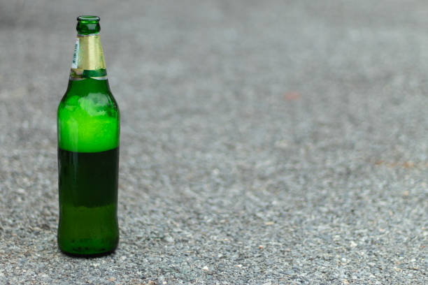 istock Green beer bottles lay on the floor. 1074126490