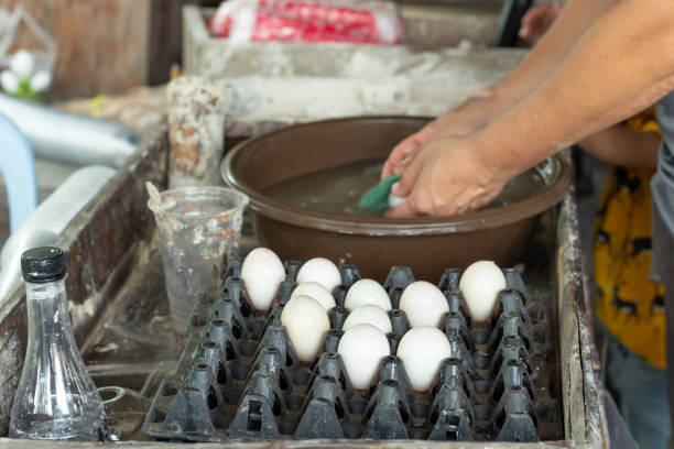 Duck eggs are washed and placed in a tray.