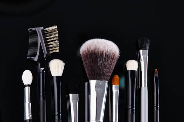 istock Various kinds of makeup brushes in the black background 1074130978