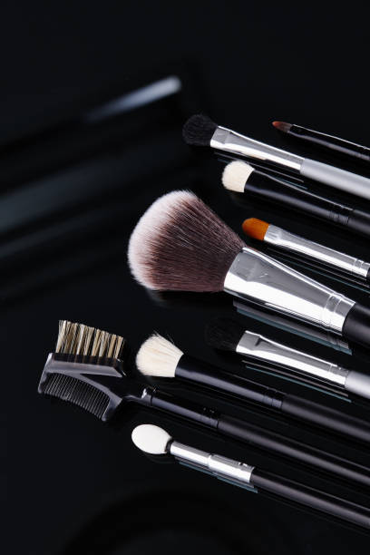 istock Various kinds of makeup brushes in the black background 1074130986