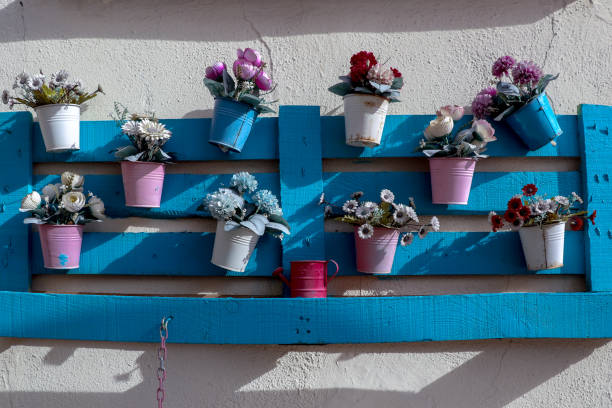 istock blue wooden case and flower pots hanging on it 1074133592