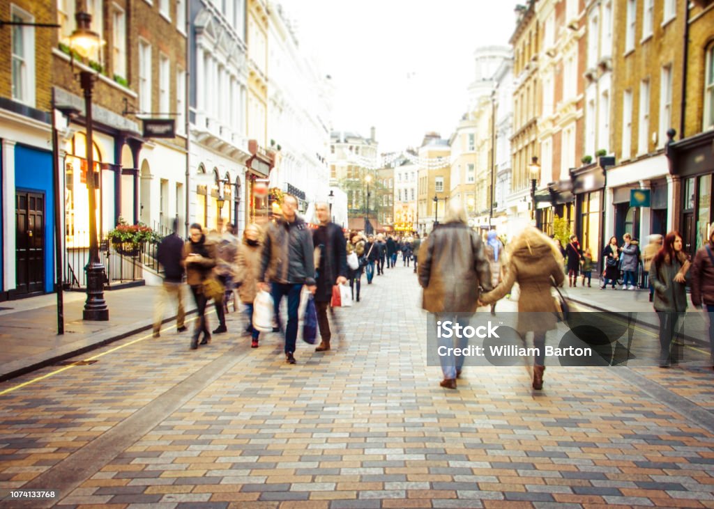 Busy shopping street Motion blurred shoppers on busy high street City Street Stock Photo