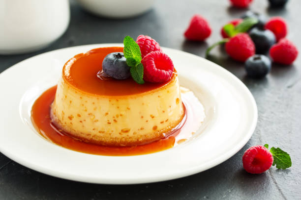 istock delicious dessert creme brulee with berries. 1074134128