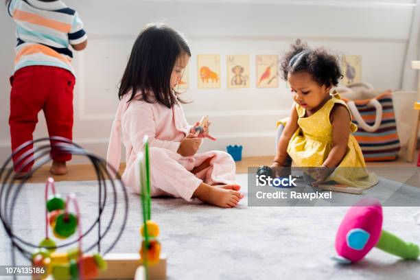 Little Kids Playing Toys In The Playroom Stock Photo - Download Image Now - Child, Child Care, Baby - Human Age