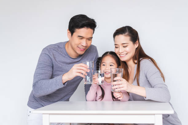 happy asian family drinking fresh water for healthy concept - glasses child cute offspring imagens e fotografias de stock