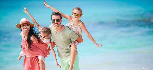Young family of four on beach vacation