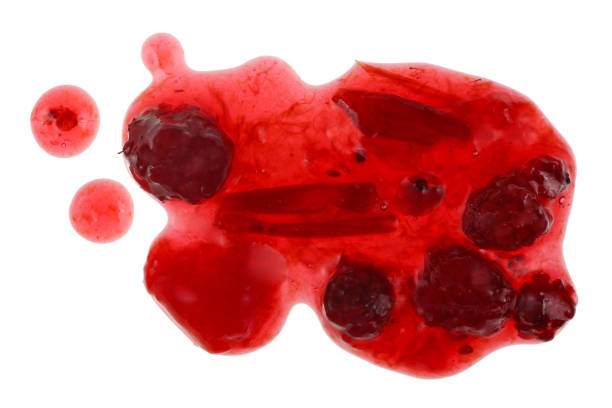Stains of the poured jam  from a blackberry and red plum. Isolated stock photo