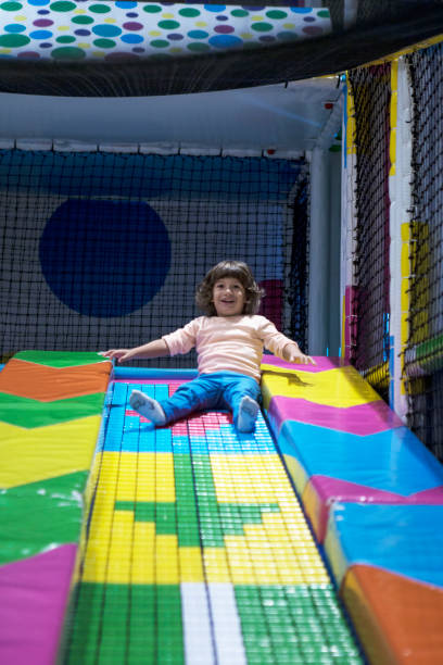 istock Smiling little Boy climbing and sliding on playground 1074145586