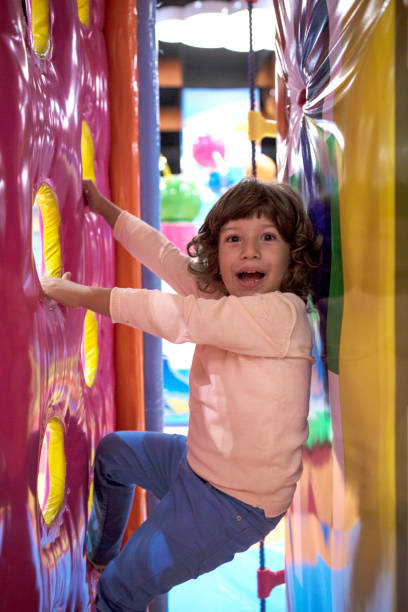 istock Smiling little Boy climbing and sliding on playground 1074146124