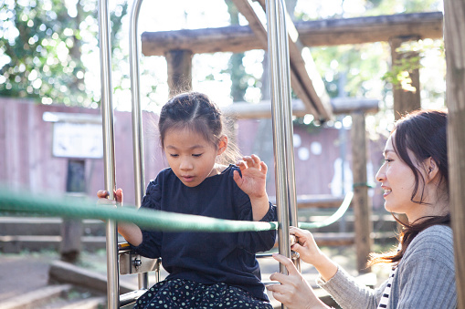 A family playing with a ropeway type plaything.