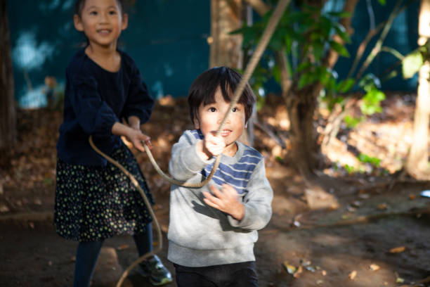 Children playing with playthings in the park. A close Siblings.
